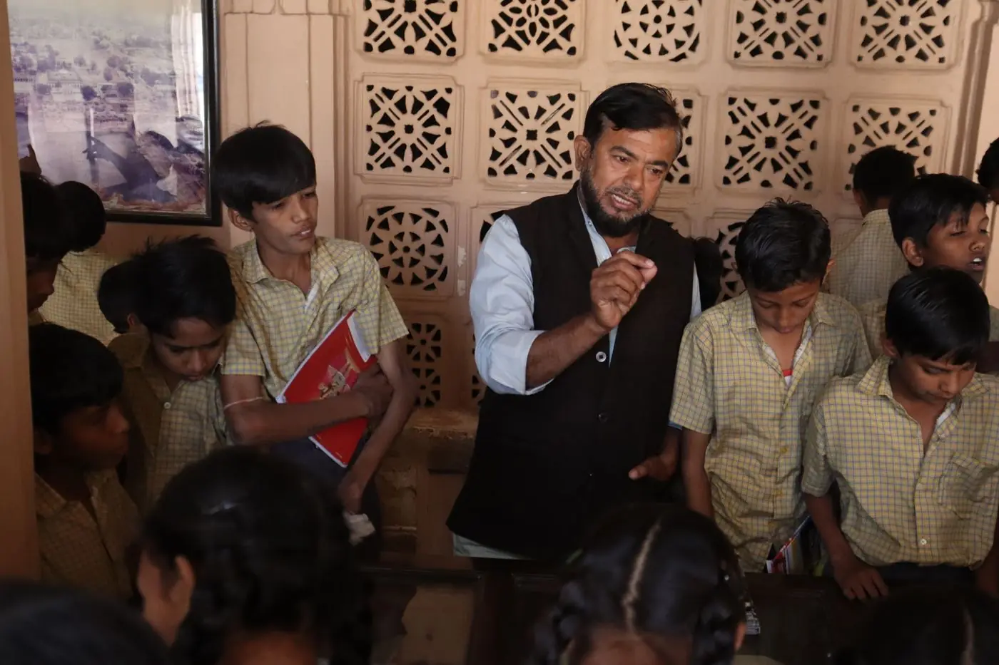 Students gathered around a presenter in a campus hall