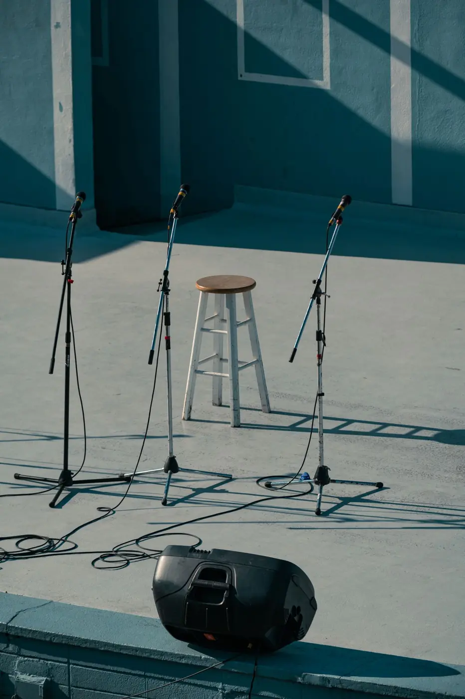 Microphone stands on an empty stage before the show